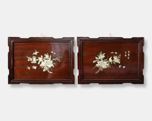 Vietnamese lacquer panels titled "Twin Blossoms," featuring detailed mother of pearl inlay depicting floral arrangements, birds, and butterflies against a dark lacquer background.