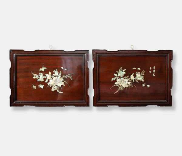 Vietnamese lacquer panels titled "Twin Blossoms," featuring detailed mother of pearl inlay depicting floral arrangements, birds, and butterflies against a dark lacquer background.