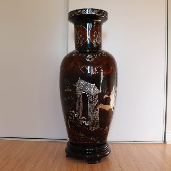 Dark brown traditional Vietnamese lacquer and mother-of-pearl vase. This side of the vase is depicting an archway.