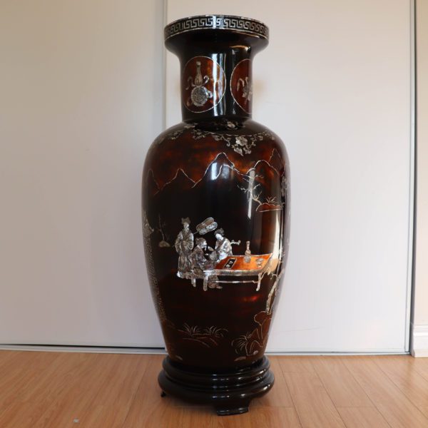 Dark brown traditional Vietnamese lacquer vase depicting a group of figures is engaged in what appears to be a scholarly or leisurely activity.