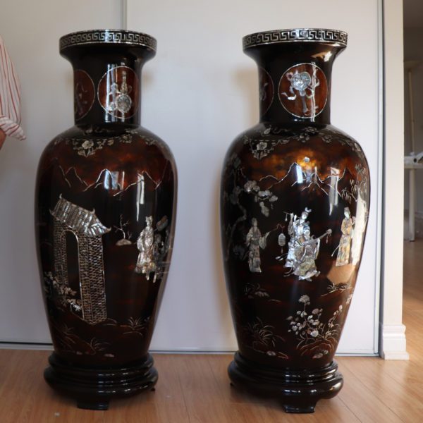 A set of 2 traditional Vietnamese lacquer and mother-of-pearl vases depicting a group of women playing musical instruments while a notable man watches them.